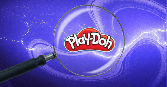 A magnifying glass hovers over the Play-Doh logo against a purple background.