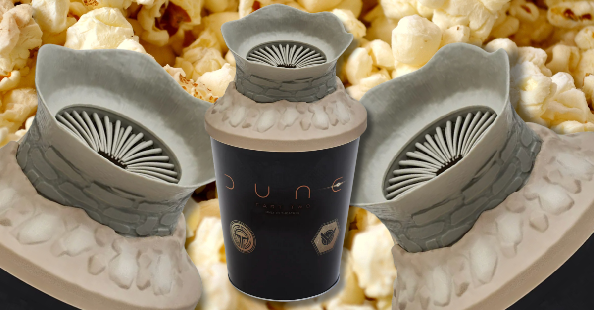 A popcorn bucket, with a close-up of popped popcorn behind it.