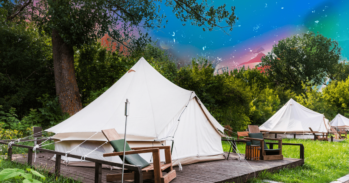 Three white canvas tents in a row with lawn chairs on decks.